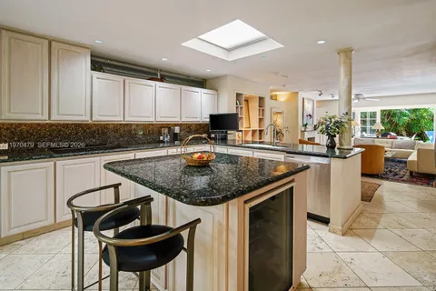 a dining room with furniture a rug and a large window