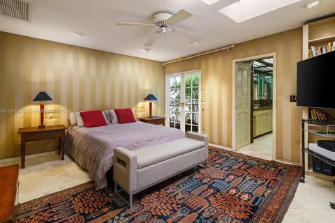 a bedroom with a large bed and a large window