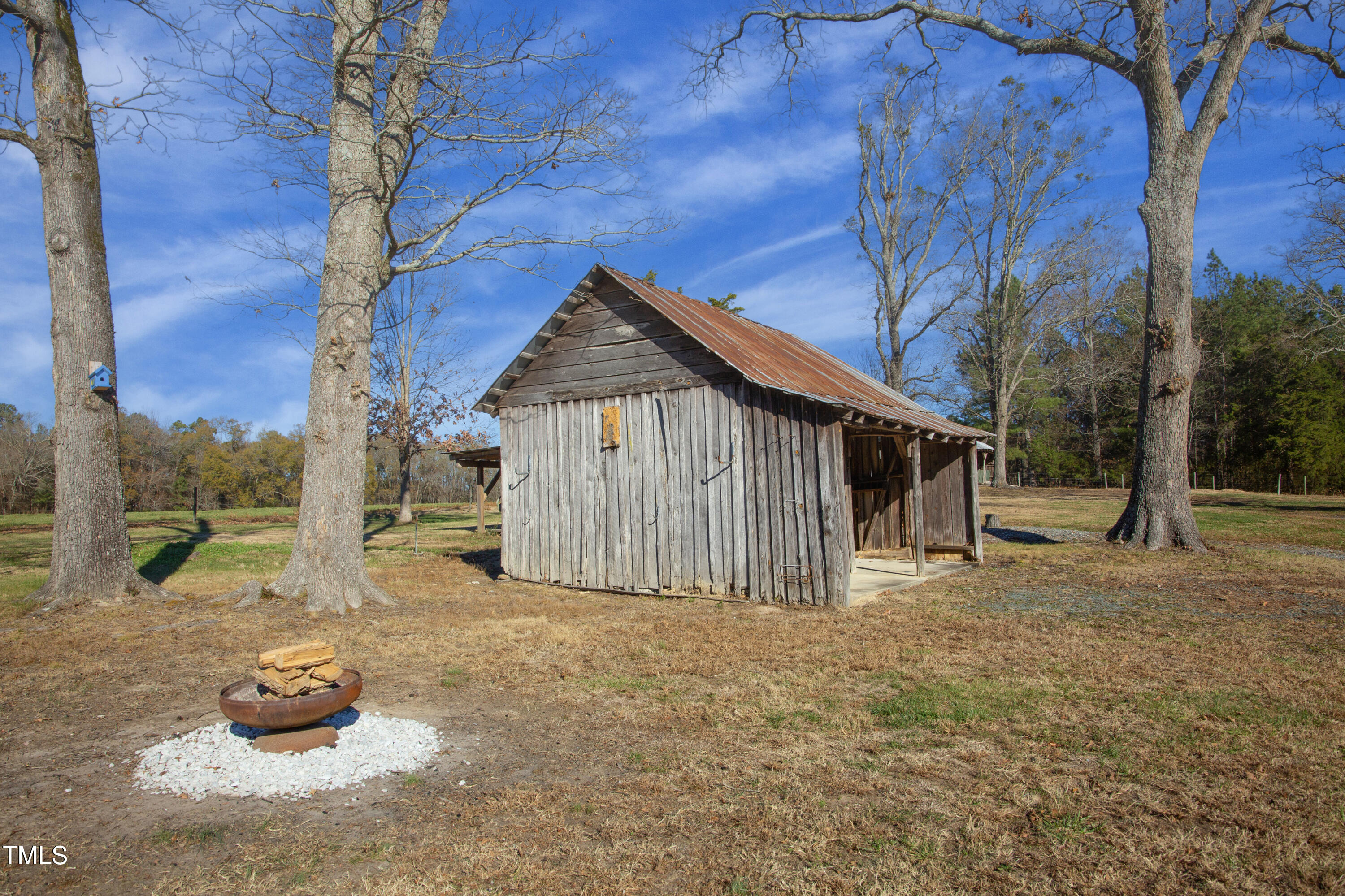 531 Archie Johnson Road Siler City, NC 27344 - Photo 15 of 46 a blue house with a large tree in the background