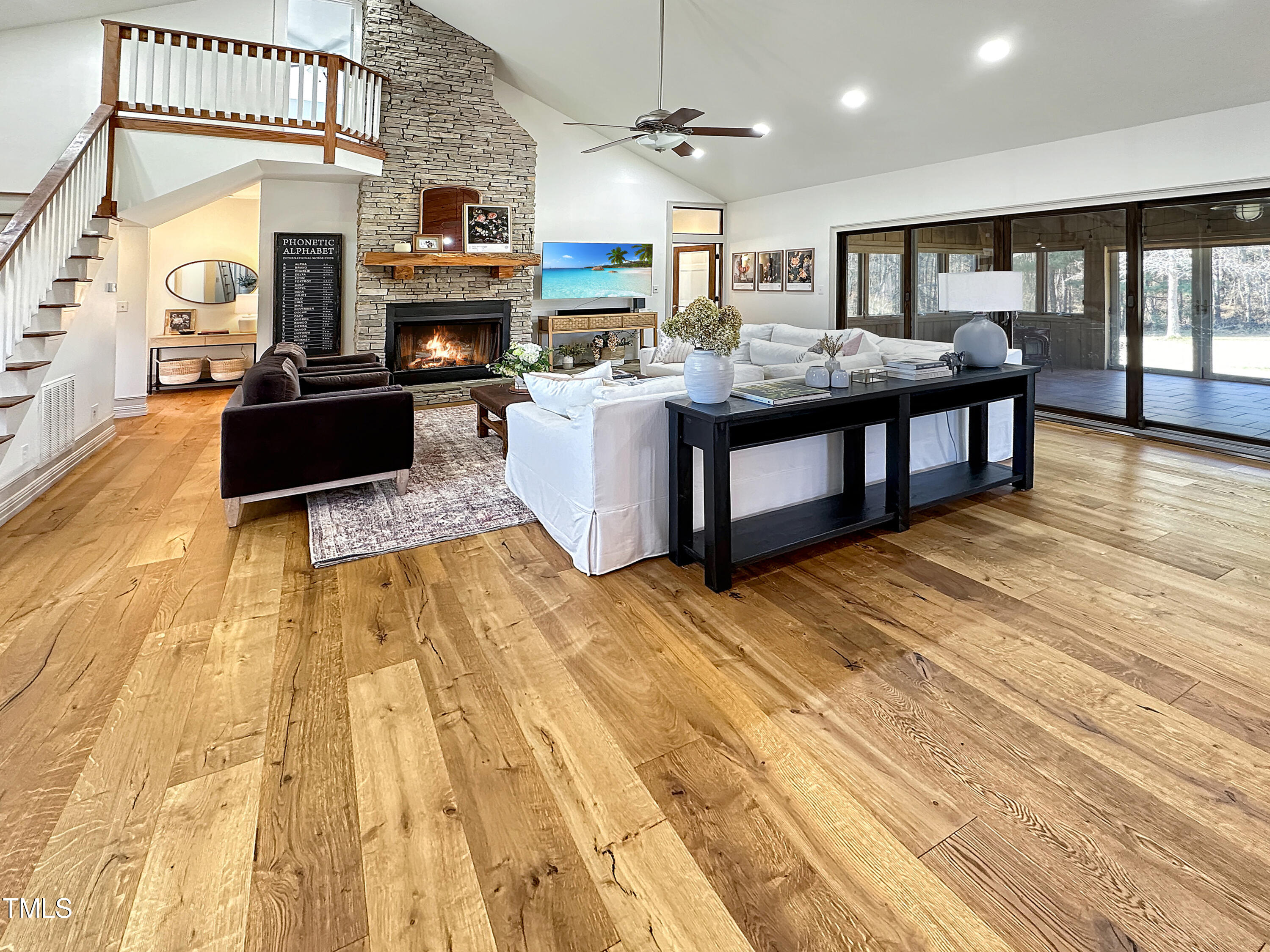 531 Archie Johnson Road Siler City, NC 27344 - Photo 26 of 46 a living room with stainless steel appliances kitchen island a large kitchen island a stove a sink dishwasher and a fireplace with wooden floor