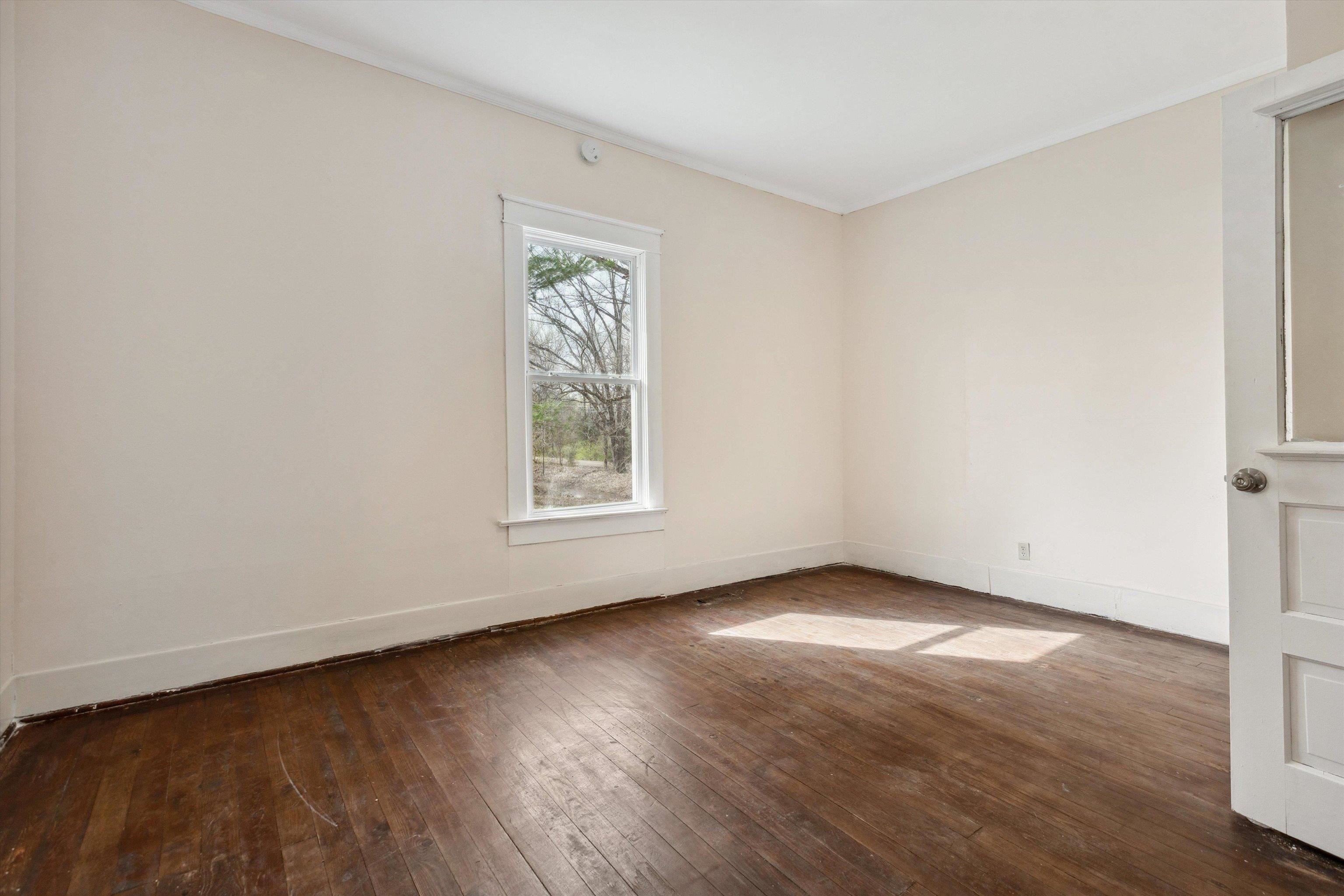 8457 East Kerrville Rosemark Road Millington, TN 38053 - Photo 12 of 32 Spare room featuring dark wood-style floors and baseboards
