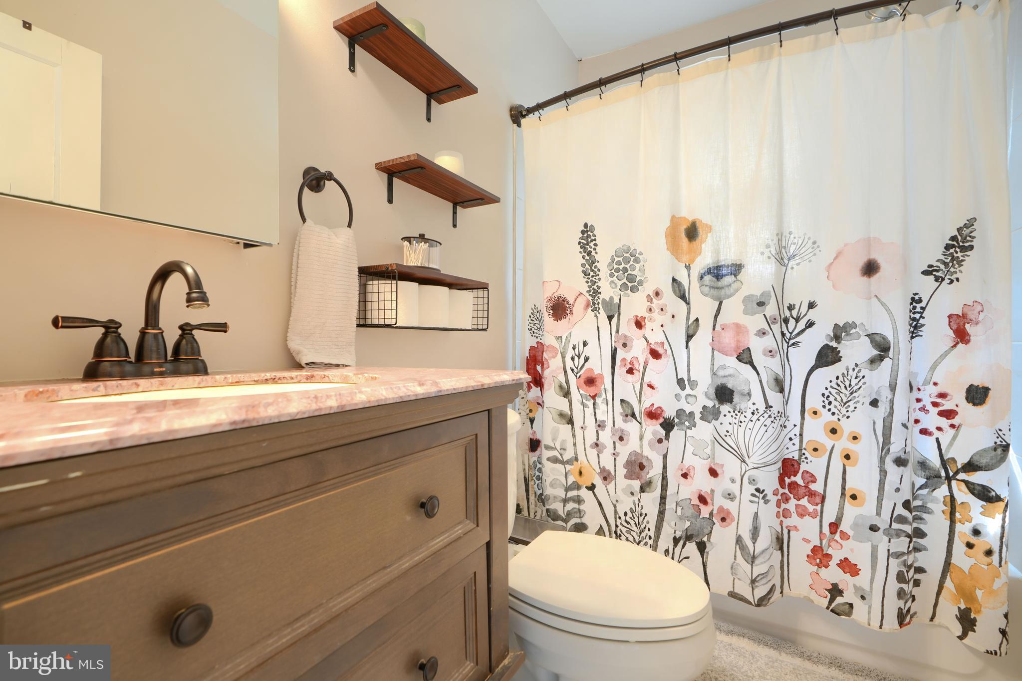 2818 Garnet Road Baltimore, MD 21234 - Photo 21 of 39 a bathroom with a granite countertop sink mirror vanity and toilet