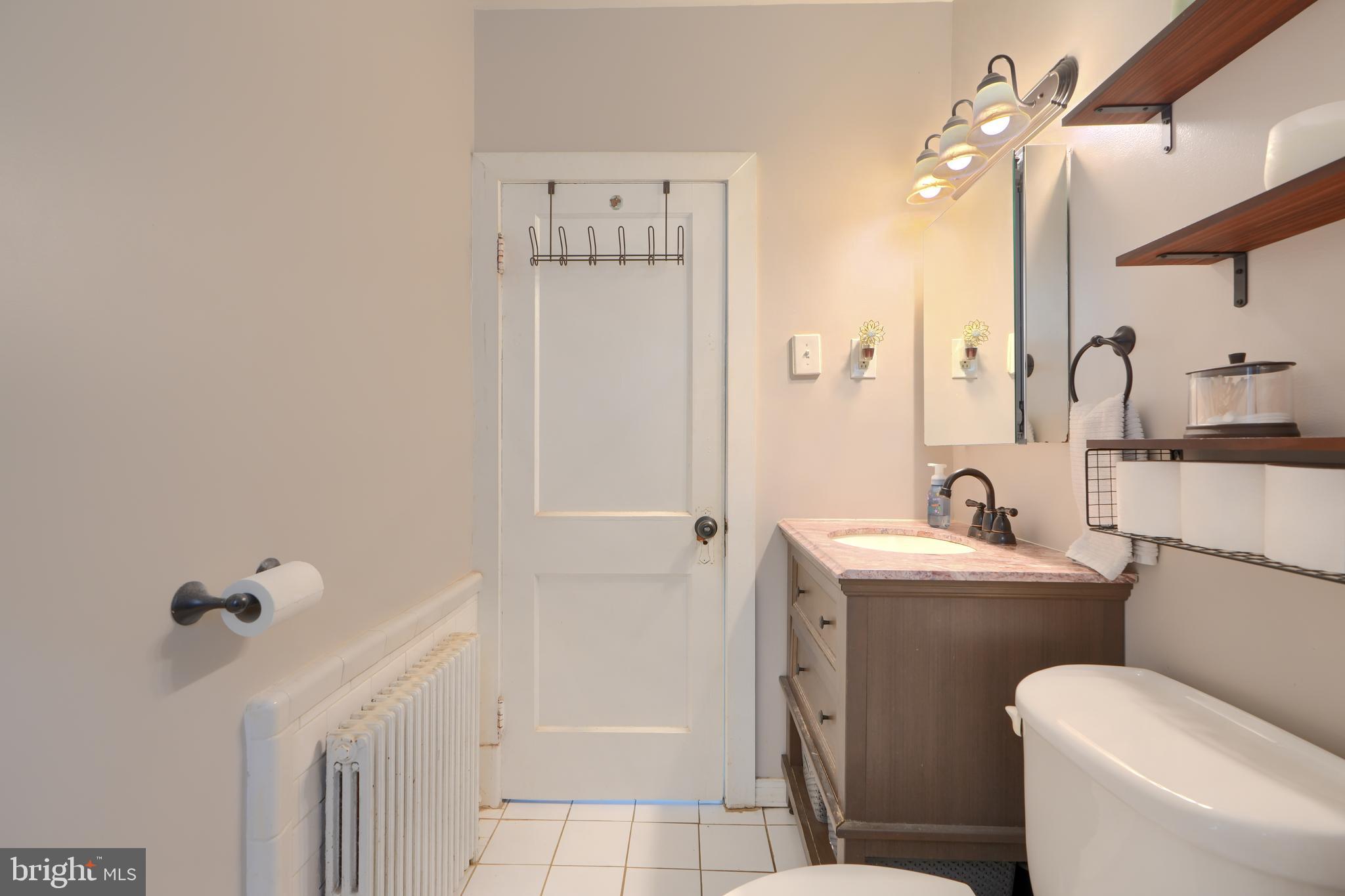 2818 Garnet Road Baltimore, MD 21234 - Photo 23 of 39 a bathroom with a sink a toilet and shower