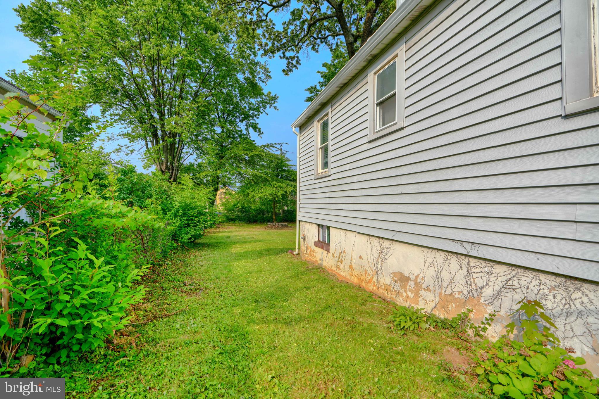 2818 Garnet Road Baltimore, MD 21234 - Photo 38 of 39 a view of a backyard with plants and large trees