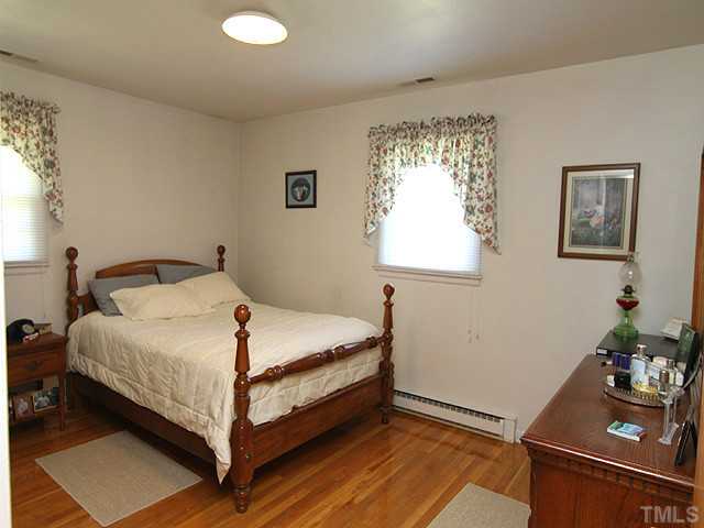 5649 Guess Road Durham, NC 27712 - Photo 5 of 12 a bedroom with a bed and a window