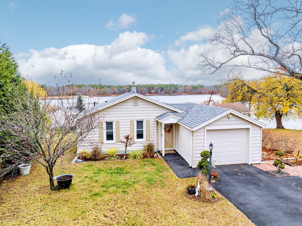 a front view of a house with yard patio and fire pit