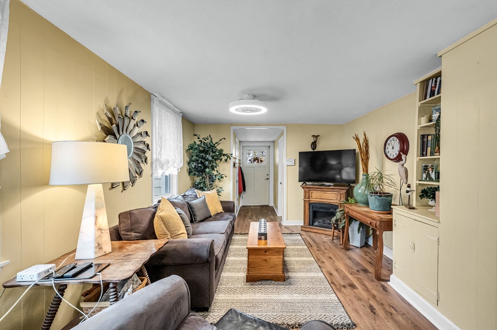 98 Pine Grove Street Springfield, MA 01119 - Photo 14 of 39 a living room with furniture a flat screen tv and a fireplace