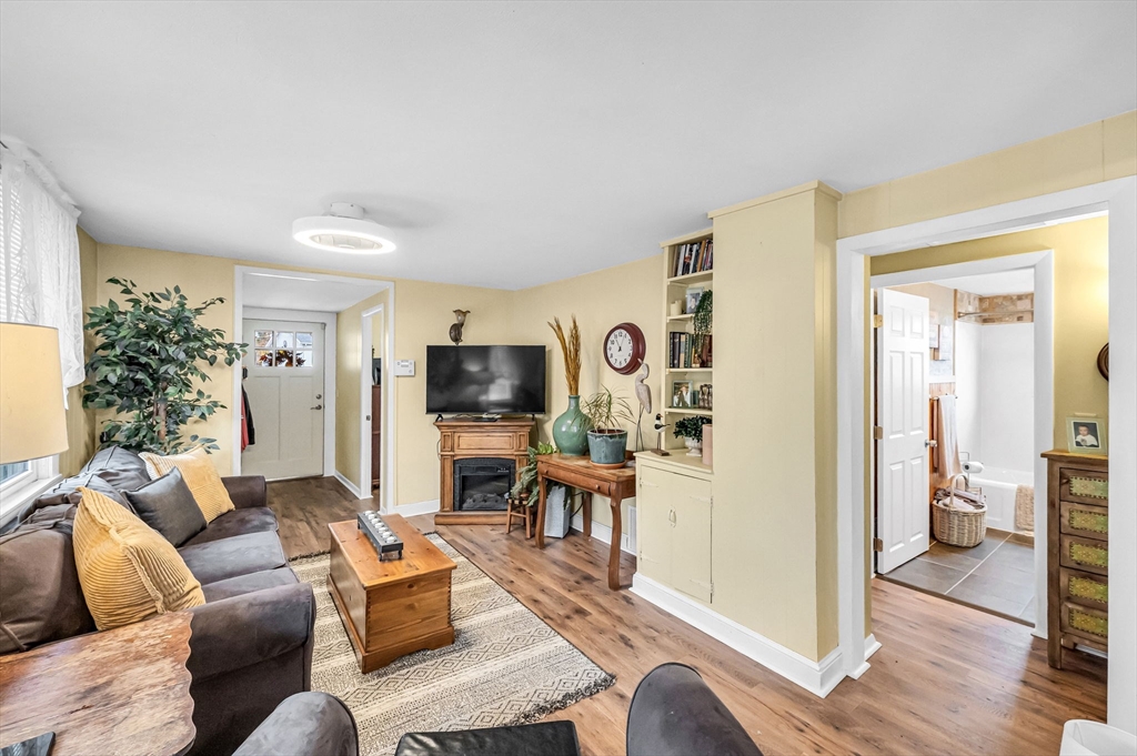 98 Pine Grove Street Springfield, MA 01119 - Photo 15 of 39 a living room with furniture a flat screen tv and a table