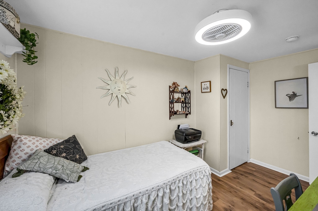 98 Pine Grove Street Springfield, MA 01119 - Photo 24 of 39 a bedroom with a bed and a chandelier