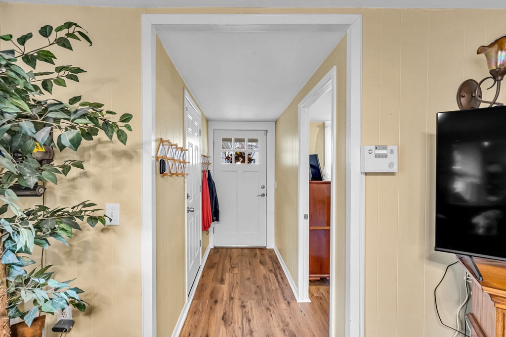 98 Pine Grove Street Springfield, MA 01119 - Photo 10 of 39 a view of a hallway with wooden floor and front door