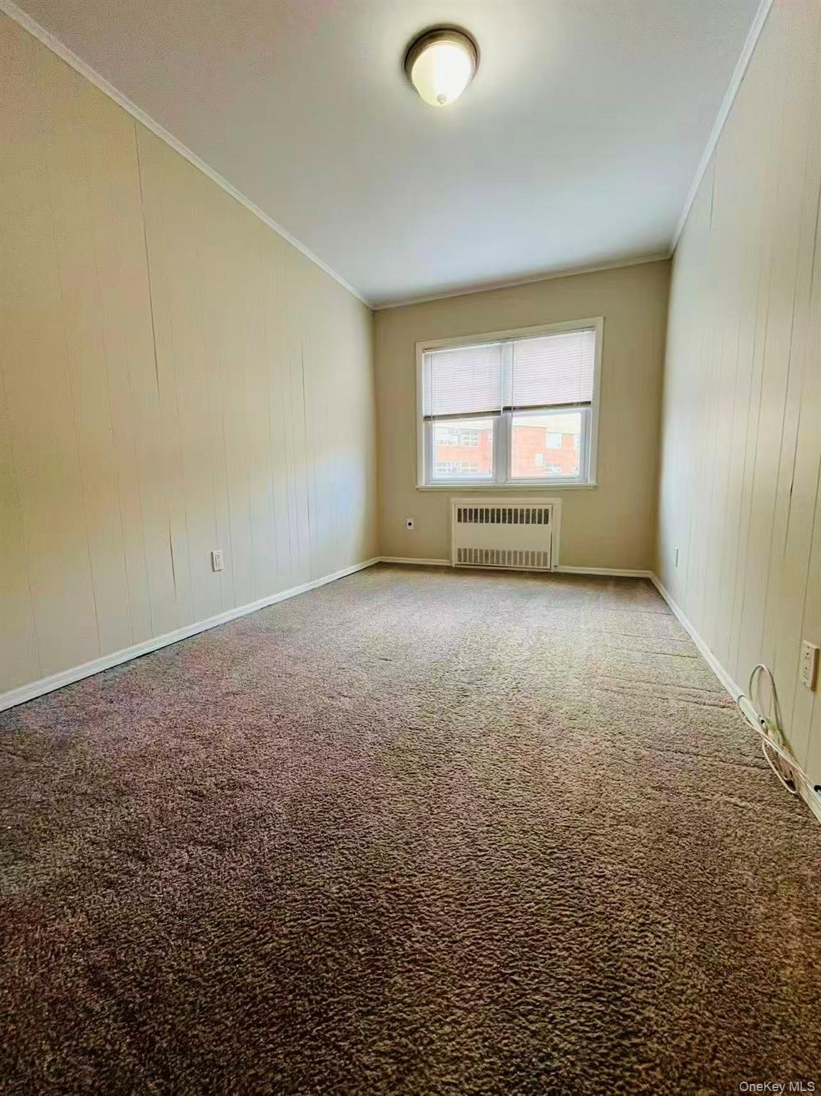 84-33 124th Street Queens, NY 11415 - Photo 16 of 27 an empty room with a window