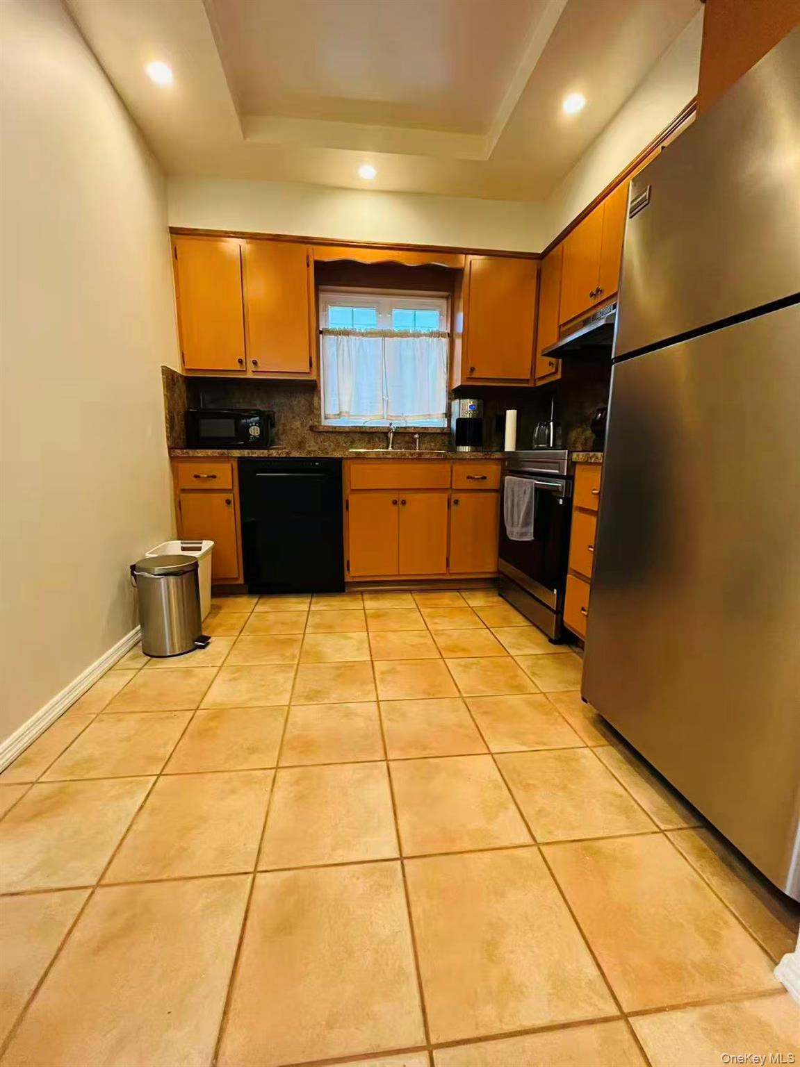 84-33 124th Street Queens, NY 11415 - Photo 18 of 27 a kitchen with stainless steel appliances granite countertop a refrigerator and a sink