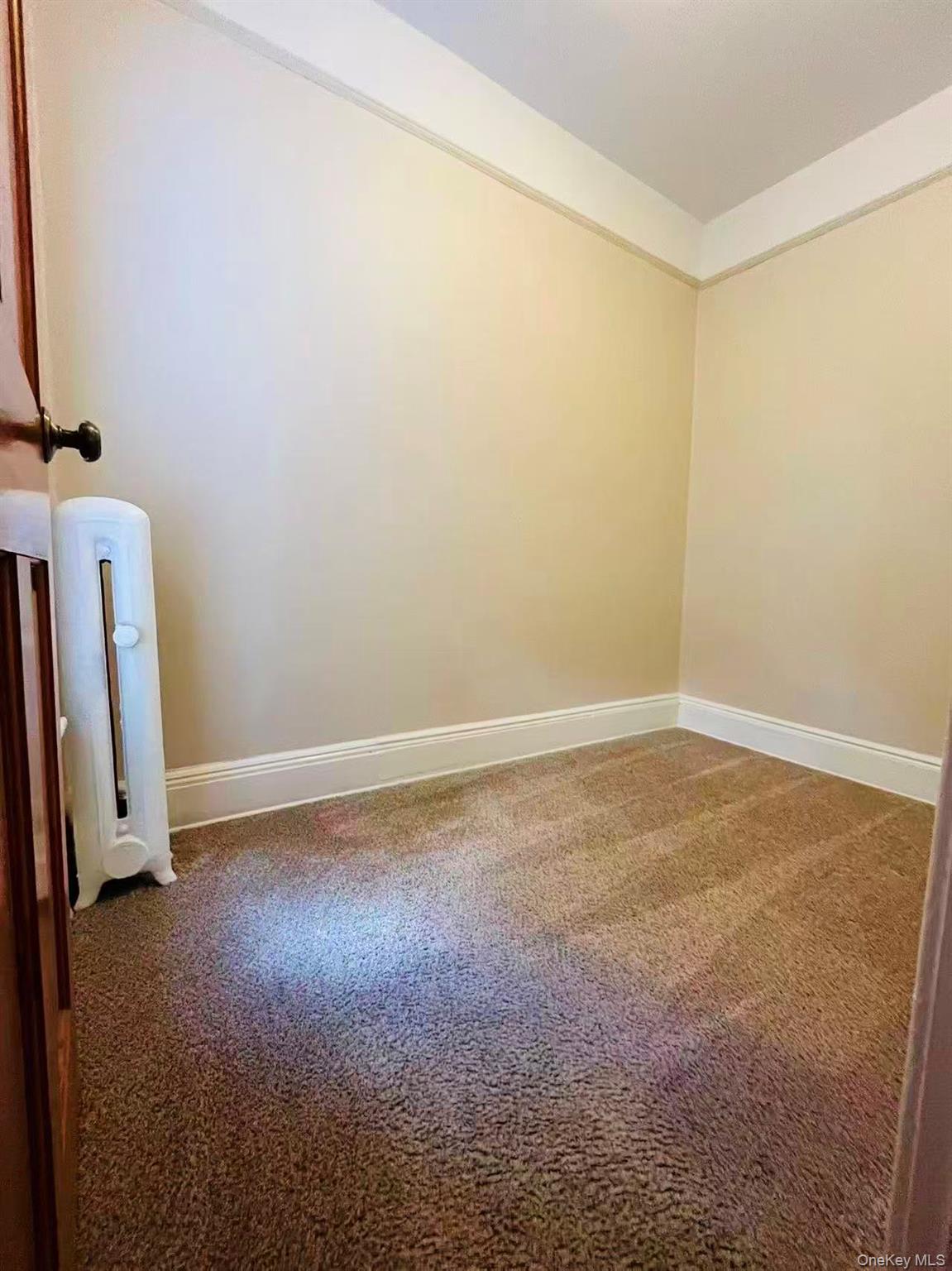 84-33 124th Street Queens, NY 11415 - Photo 21 of 27 an empty room with a mirror