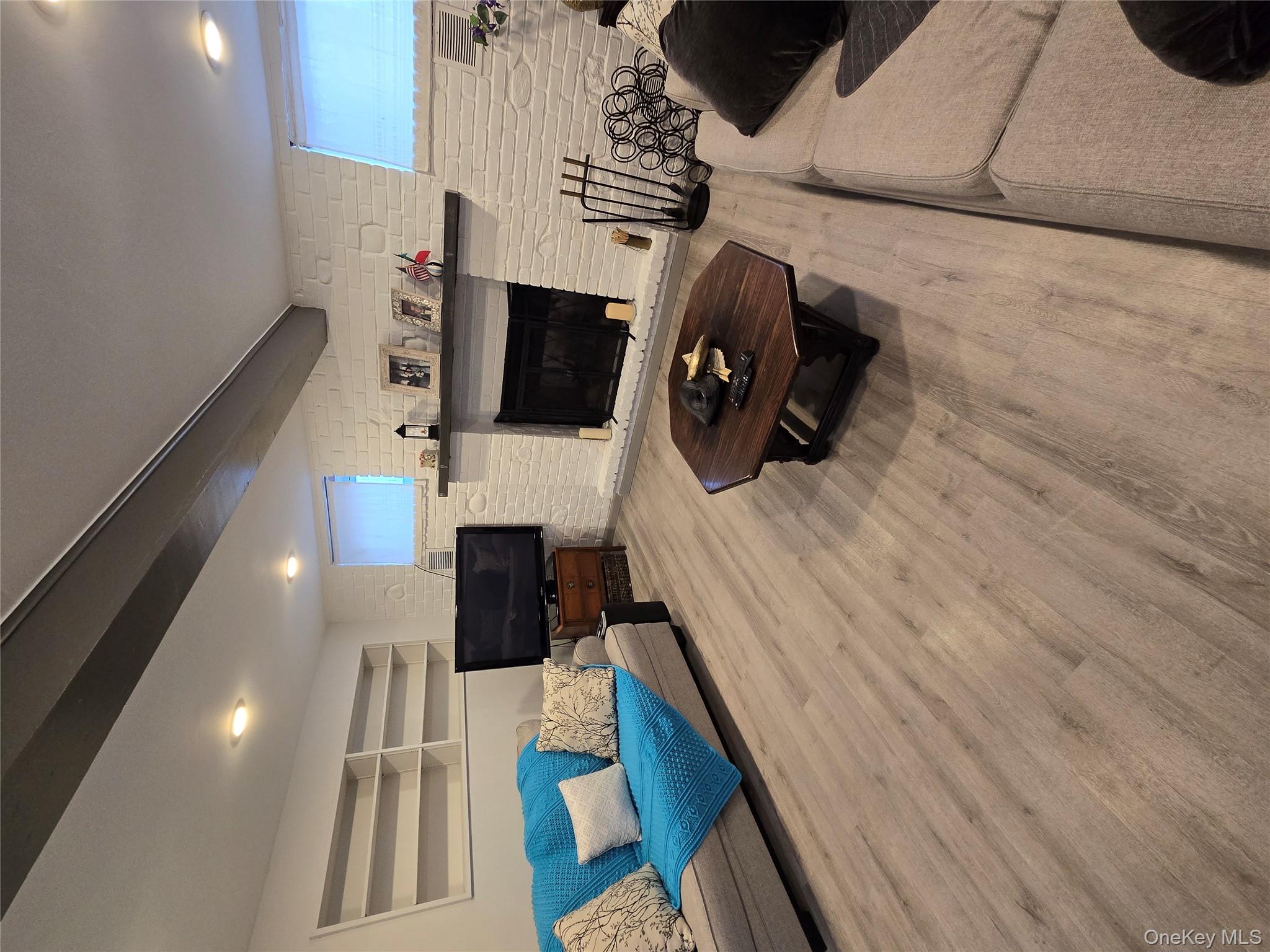 84-33 124th Street Queens, NY 11415 - Photo 23 of 27 a living room with furniture and a fireplace