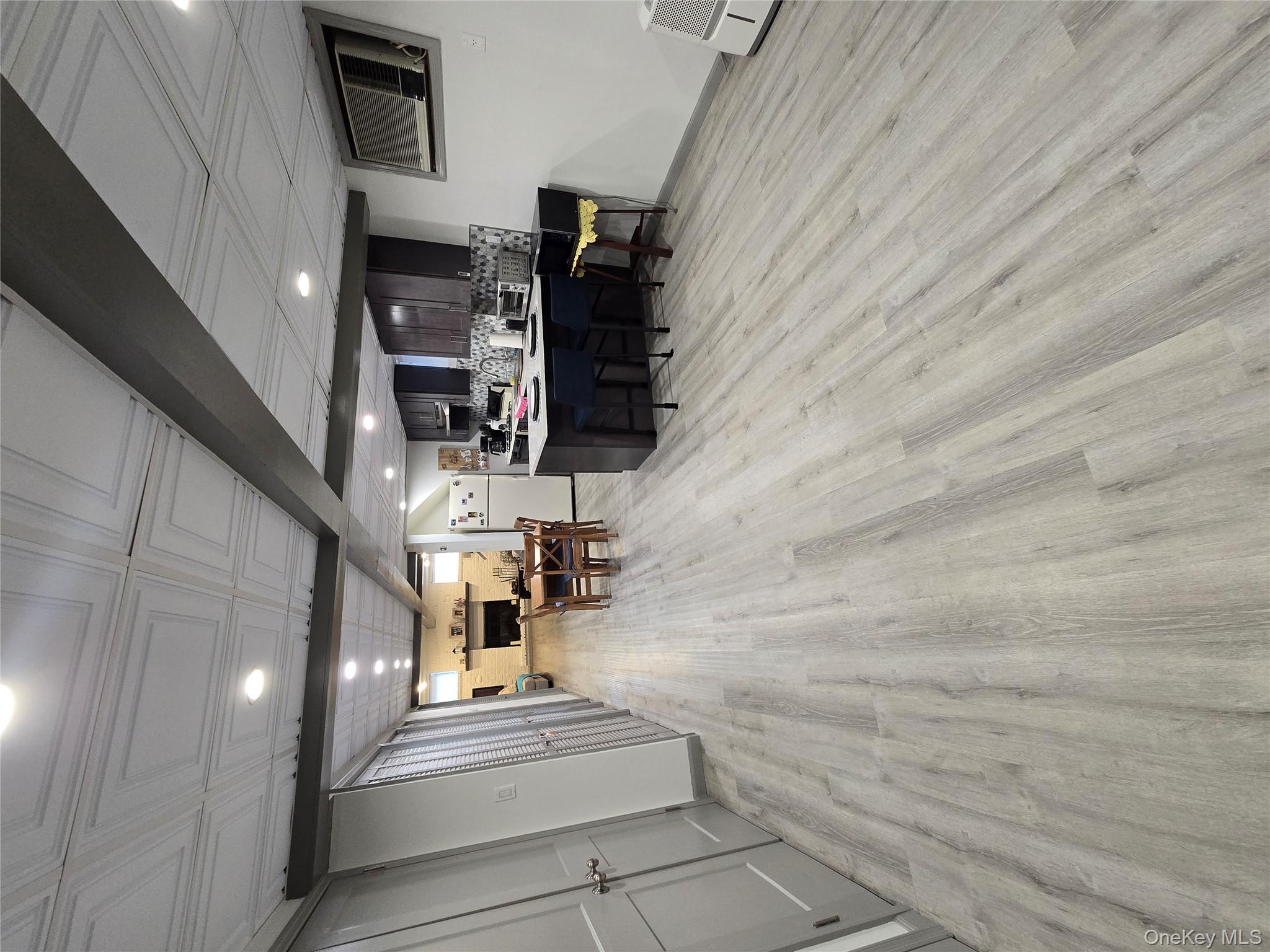 84-33 124th Street Queens, NY 11415 - Photo 26 of 27 a room with furniture and a wooden floor