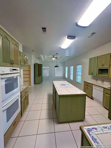 a view kitchen with stainless steel appliances granite countertop a stove and a sink