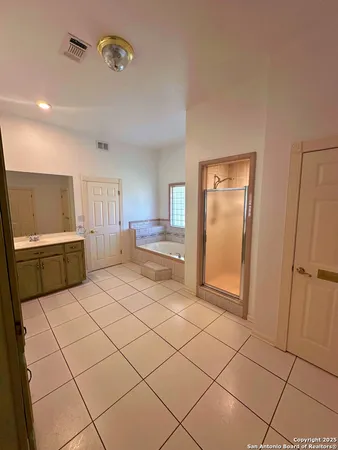 a large white kitchen with a sink