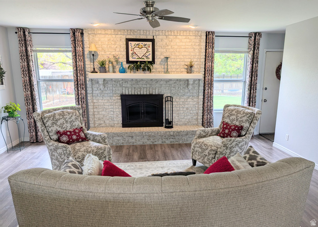 897 East 1200 North Mapleton, UT 84664 - Photo 2 of 54 Living area with a brick fireplace, wood finished floors, and a ceiling fan