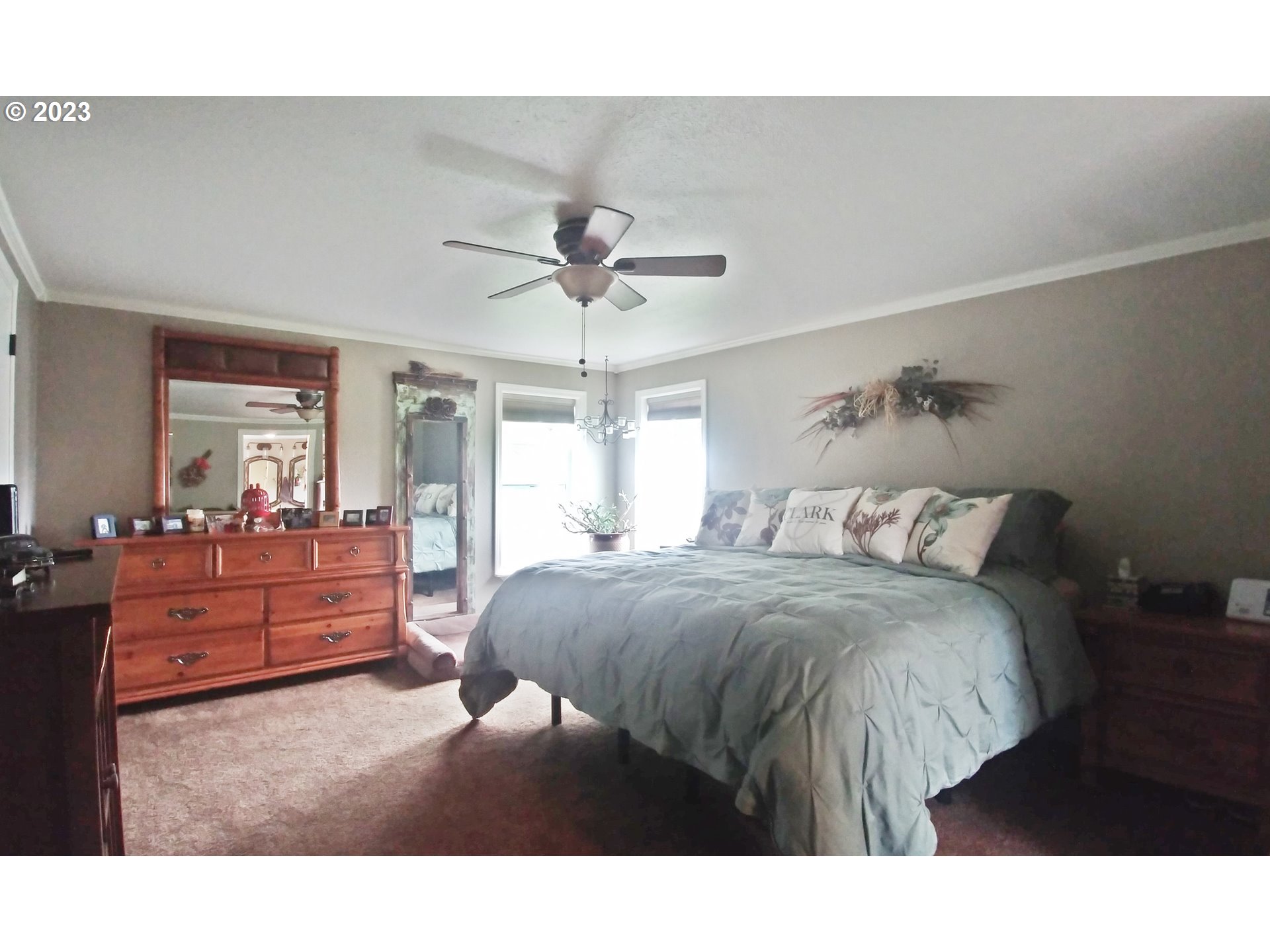 700 North Russell Street Joseph, OR 97846 - Photo 20 of 34 a spacious bedroom with a bed and a chandelier
