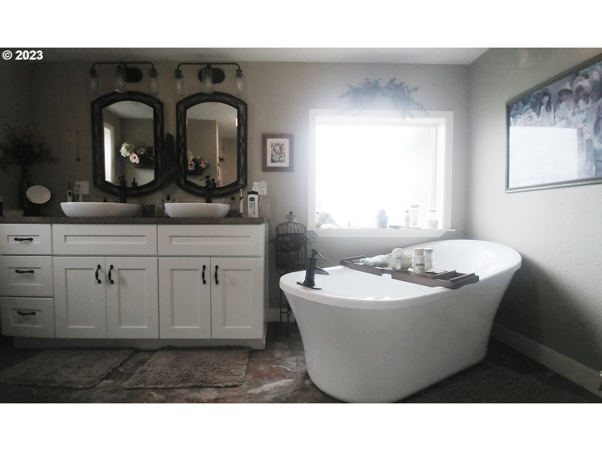 700 North Russell Street Joseph, OR 97846 - Photo 22 of 34 a bathroom with a sink mirror vanity and bathtub