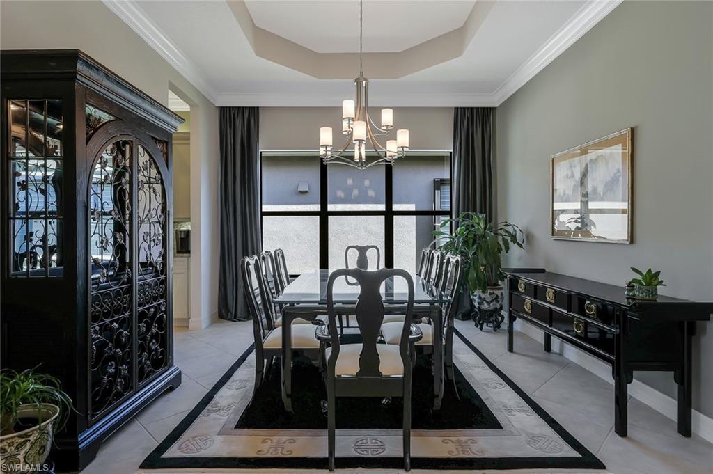 3384 Atlantic Circle Naples, FL 34119 - Photo 16 of 50 a view of a dining room with furniture and chandelier