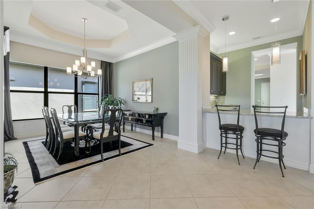 3384 Atlantic Circle Naples, FL 34119 - Photo 17 of 50 a view of a dining room with furniture and chandelier