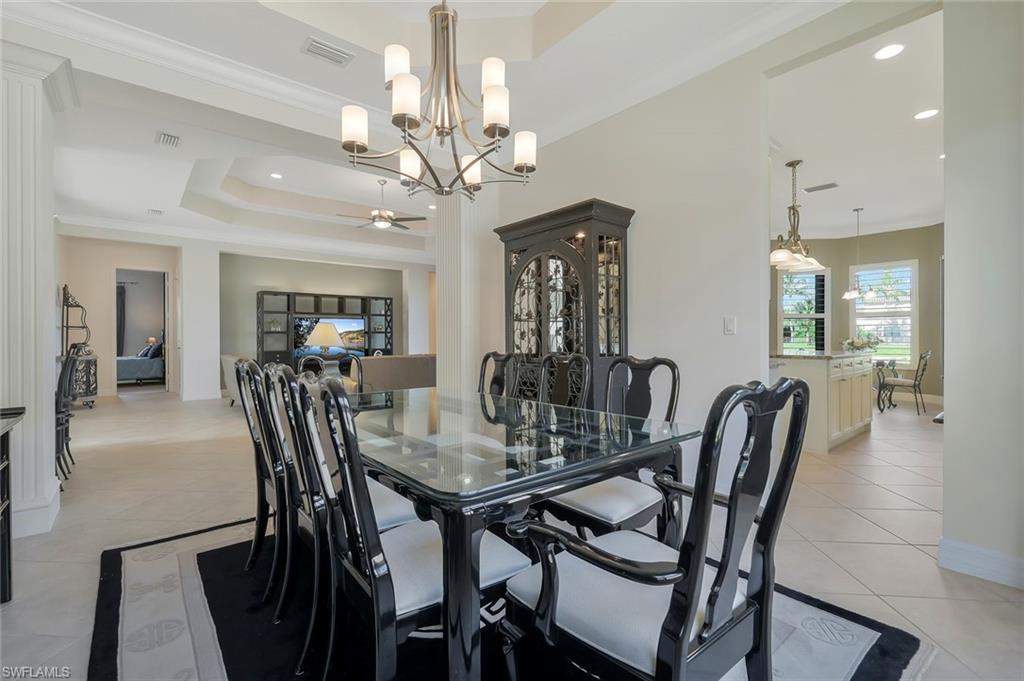 3384 Atlantic Circle Naples, FL 34119 - Photo 18 of 50 a view of a dining room with furniture and chandelier