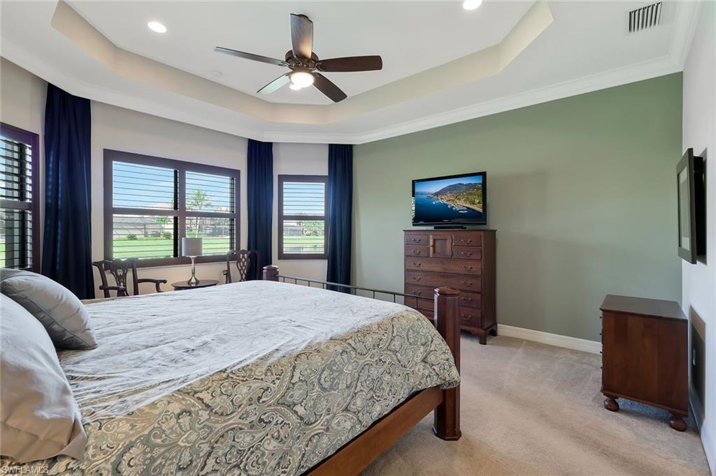 3384 Atlantic Circle Naples, FL 34119 - Photo 20 of 50 a bedroom with a bed and a flat screen television