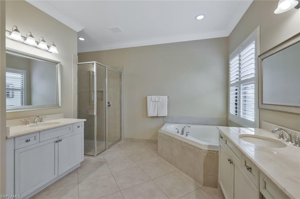 3384 Atlantic Circle Naples, FL 34119 - Photo 21 of 50 a spacious bathroom with a double vanity sink mirror and bathtub