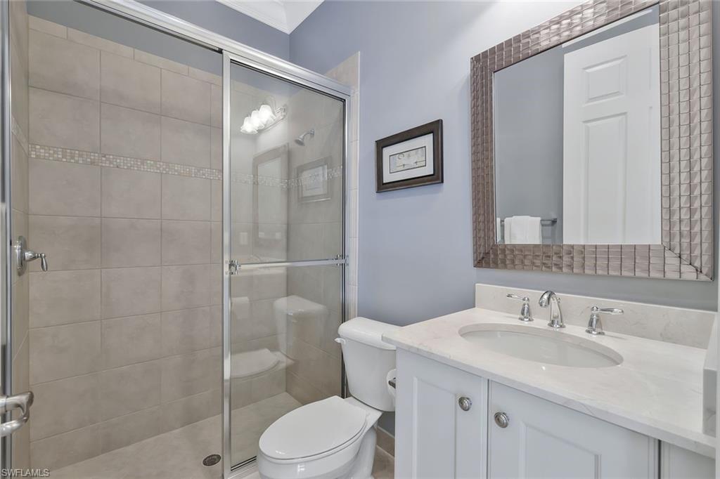 3384 Atlantic Circle Naples, FL 34119 - Photo 27 of 50 a bathroom with a sink toilet and shower