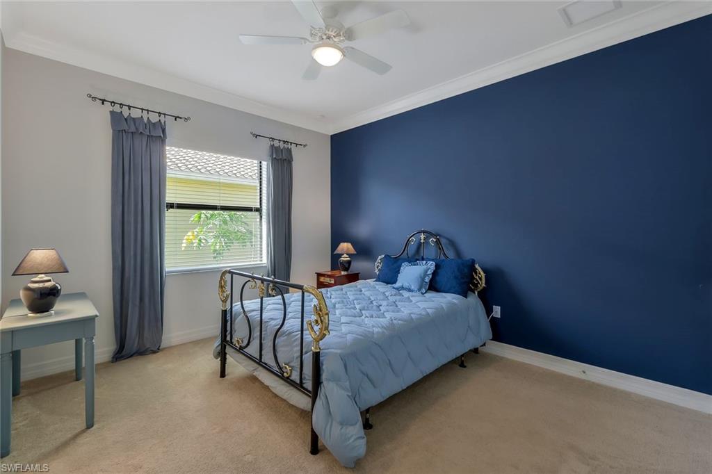 3384 Atlantic Circle Naples, FL 34119 - Photo 28 of 50 a bed sitting in a bedroom next to a window