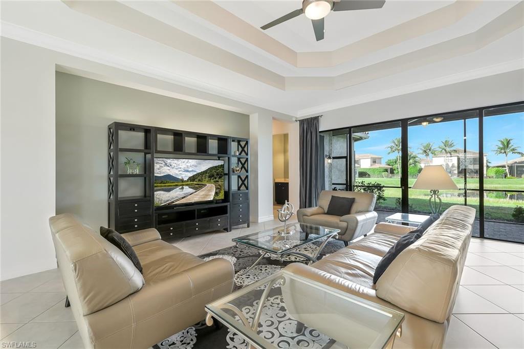 3384 Atlantic Circle Naples, FL 34119 - Photo 3 of 50 a living room with furniture and a flat screen tv