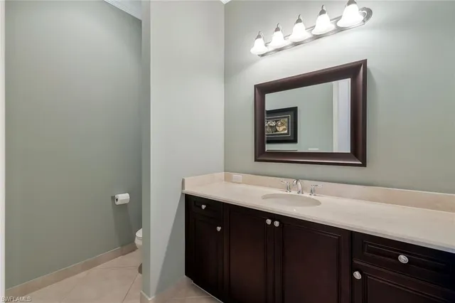 a bathroom with a sink vanity and a mirror