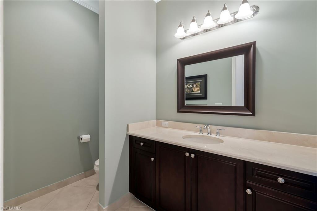 3384 Atlantic Circle Naples, FL 34119 - Photo 31 of 50 a bathroom with a sink vanity and a mirror
