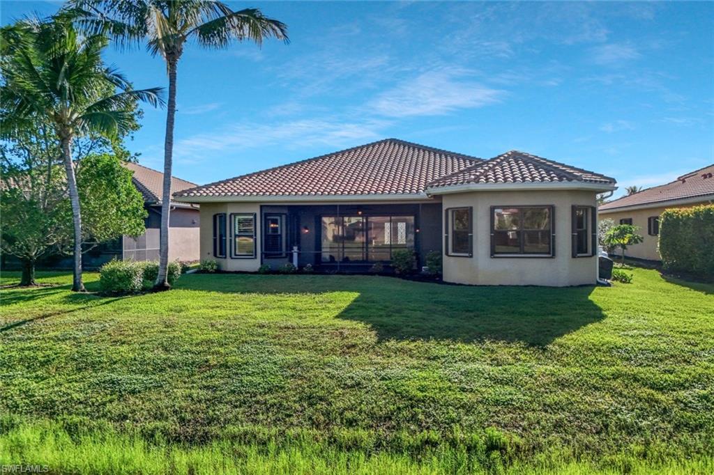 3384 Atlantic Circle Naples, FL 34119 - Photo 37 of 50 a front view of a house with a yard table and chairs