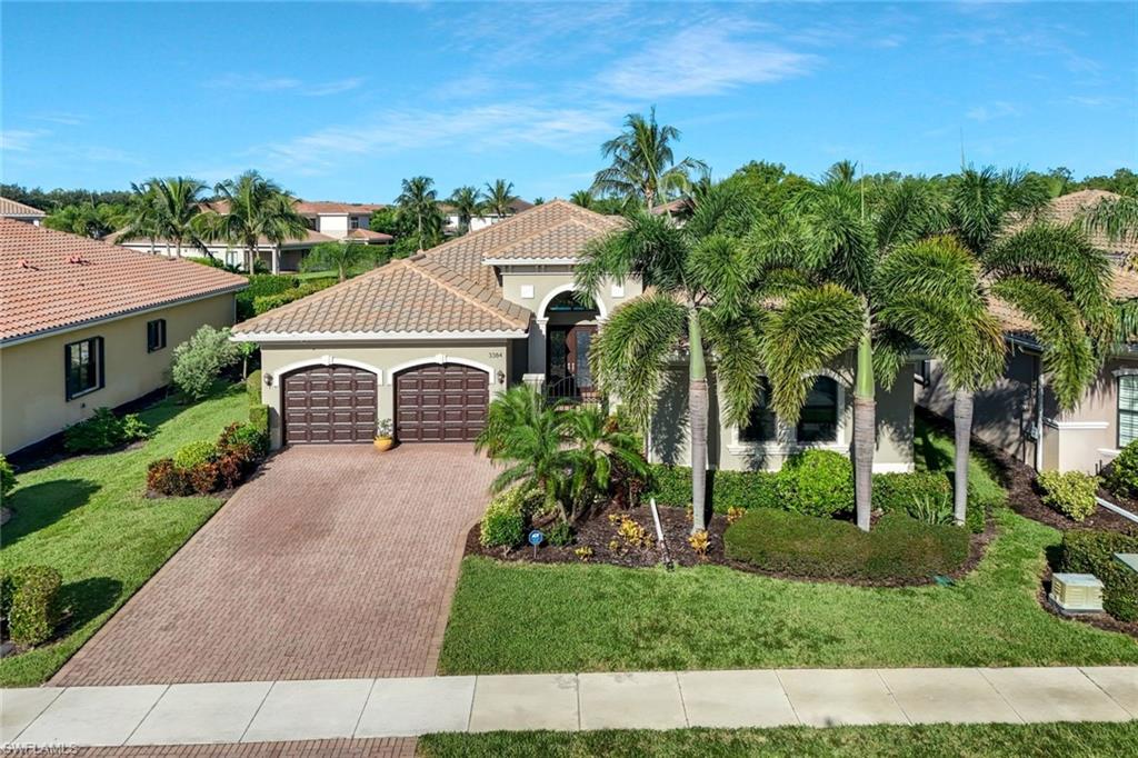 3384 Atlantic Circle Naples, FL 34119 - Photo 38 of 50 a front view of a house with a garden