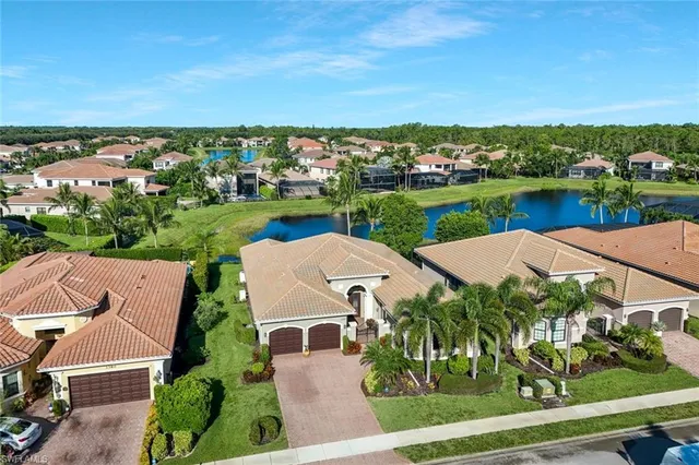 an aerial view of a house with a garden and lake view