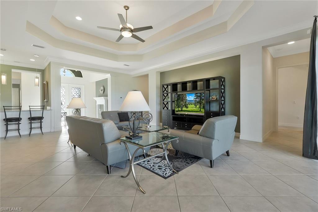 3384 Atlantic Circle Naples, FL 34119 - Photo 5 of 50 a living room with furniture a ceiling fan and a rug
