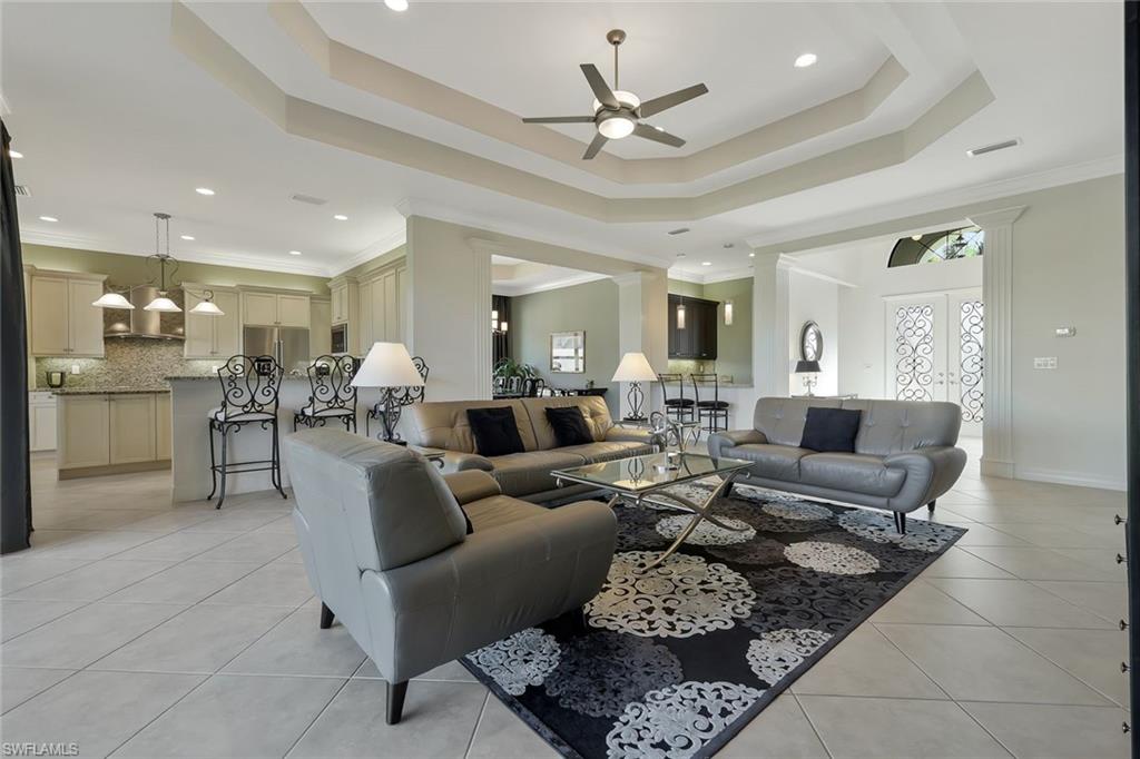 3384 Atlantic Circle Naples, FL 34119 - Photo 6 of 50 a living room with furniture kitchen view and a chandelier