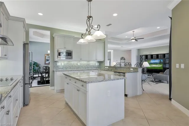 a kitchen with a sink a counter top space appliances and cabinets