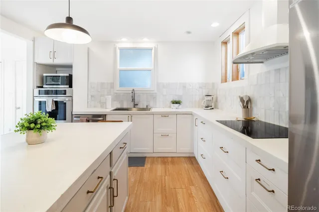 a kitchen with cabinets a sink and appliances