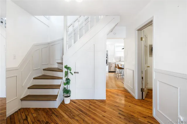 a view of a hallway view with wooden floor and staircase