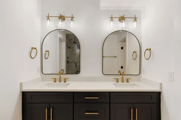 a bathroom with a double vanity sink and a mirror