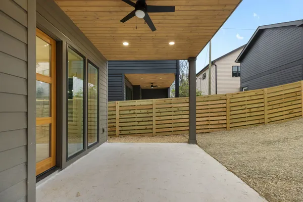 a view of a porch with a table and chairs