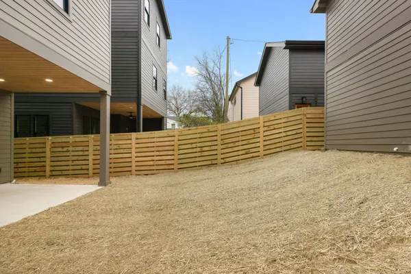 a view of house with wooden fence