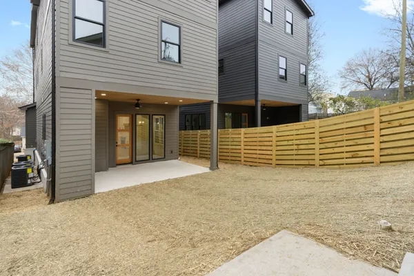 a view of a house with a wooden fence