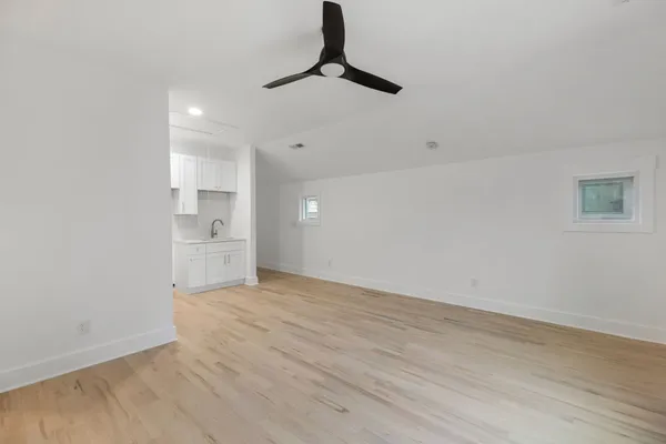 a view of empty room with wooden floor