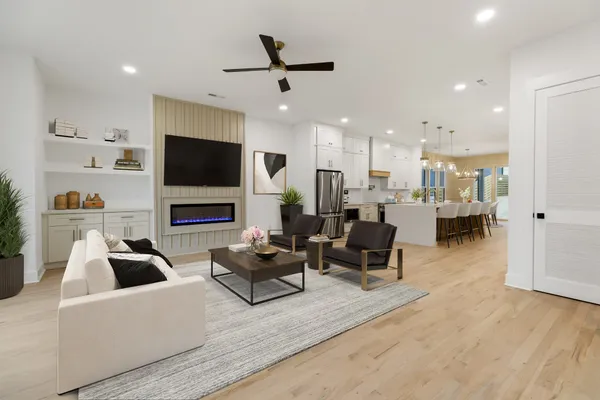 a living room with fireplace furniture and a flat screen tv