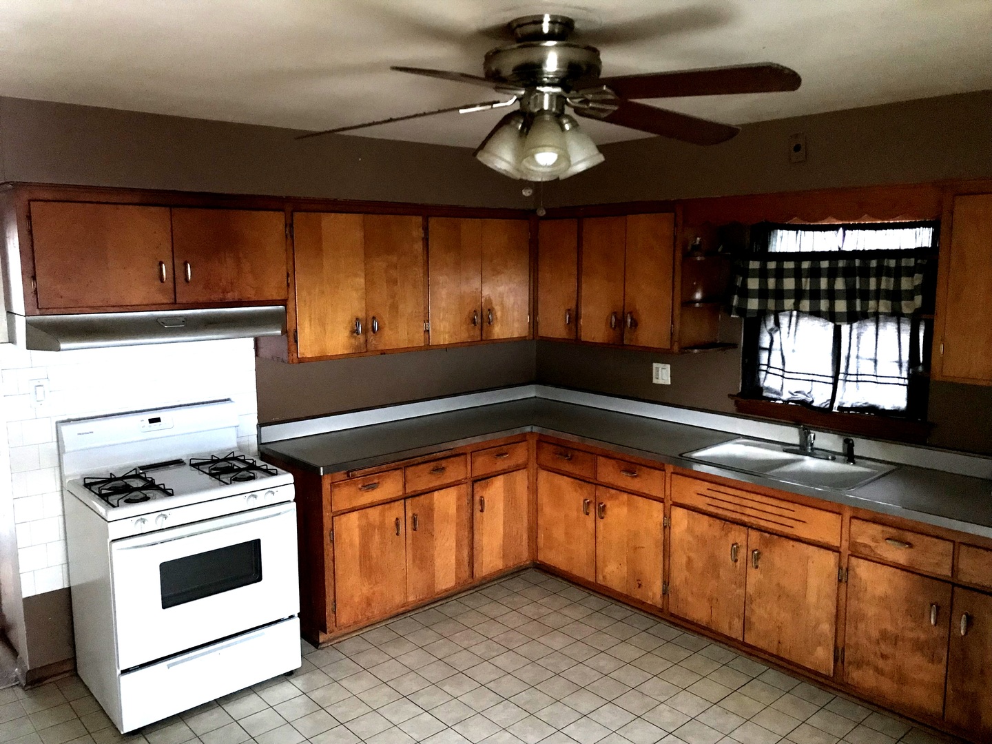 7331 Ogden Avenue Lyons, IL 60534 - Photo 9 of 15 a kitchen with stainless steel appliances kitchen island granite countertop a sink and a stove