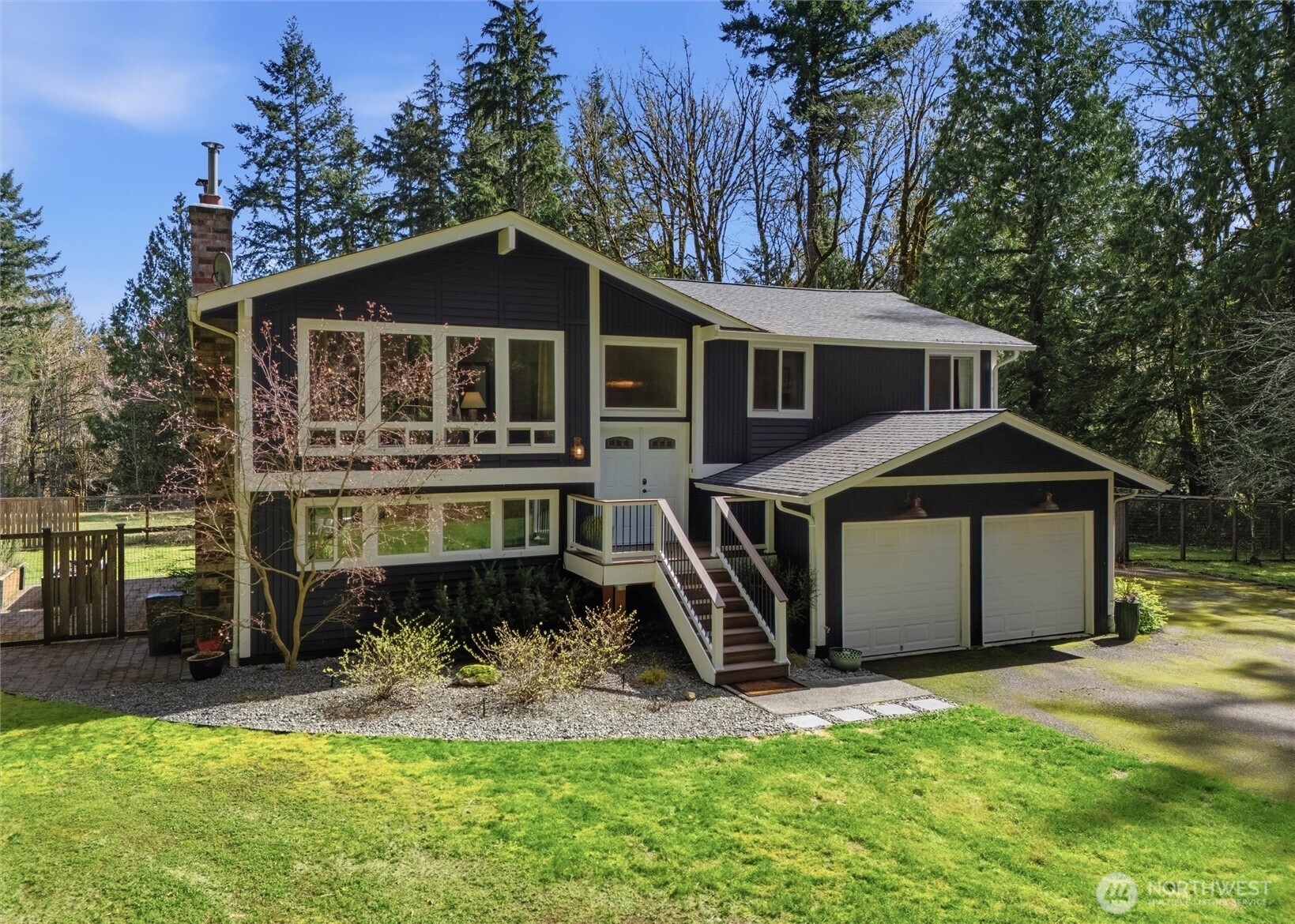 2065 Opdal Road East Port Orchard, WA 98366 - Photo 1 of 40 a front view of a house with a yard and large trees